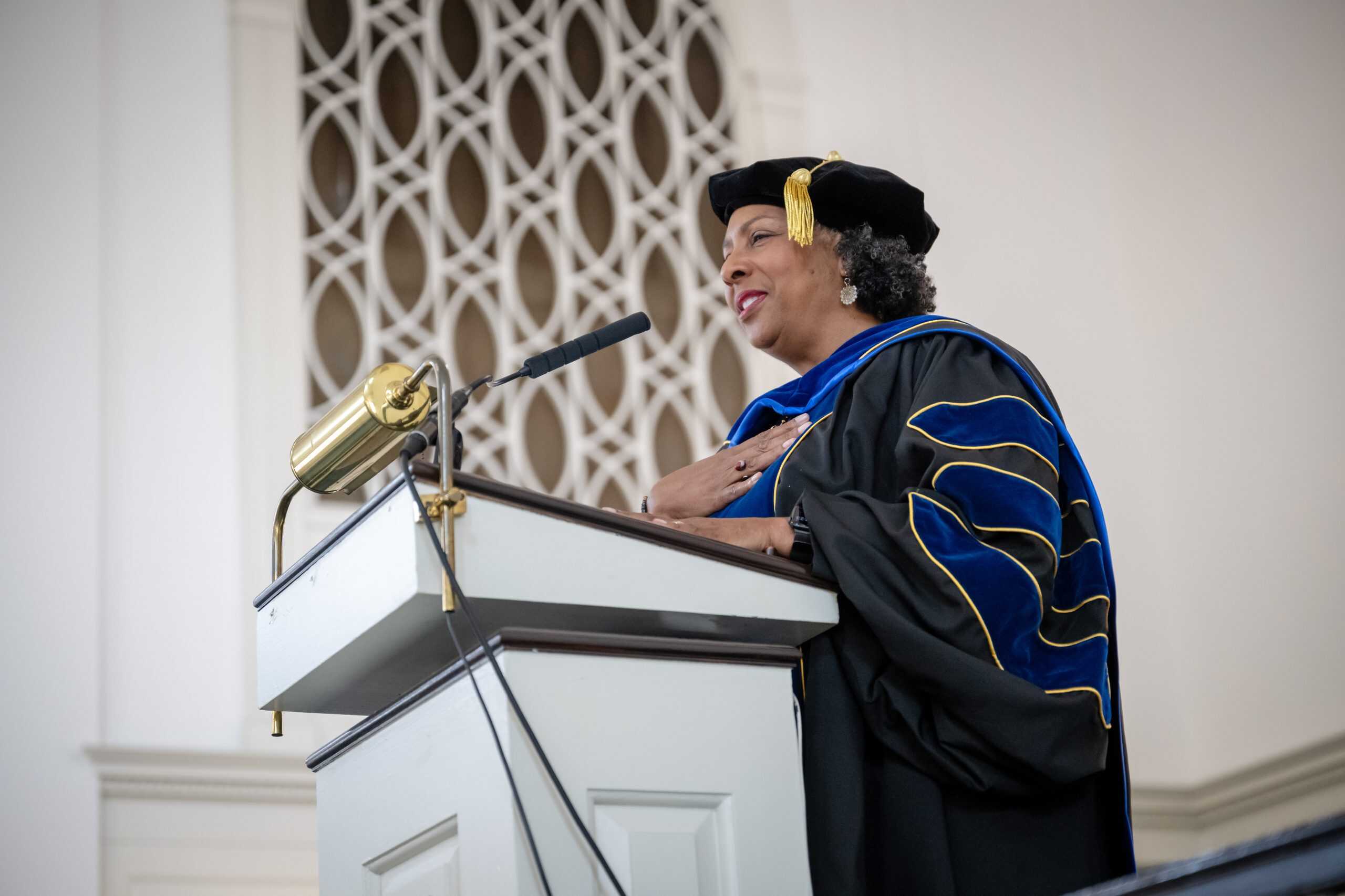 Keynote Speaker, Phanalphie Rhue addressing  the audience from the podium during the Honors Convocation.